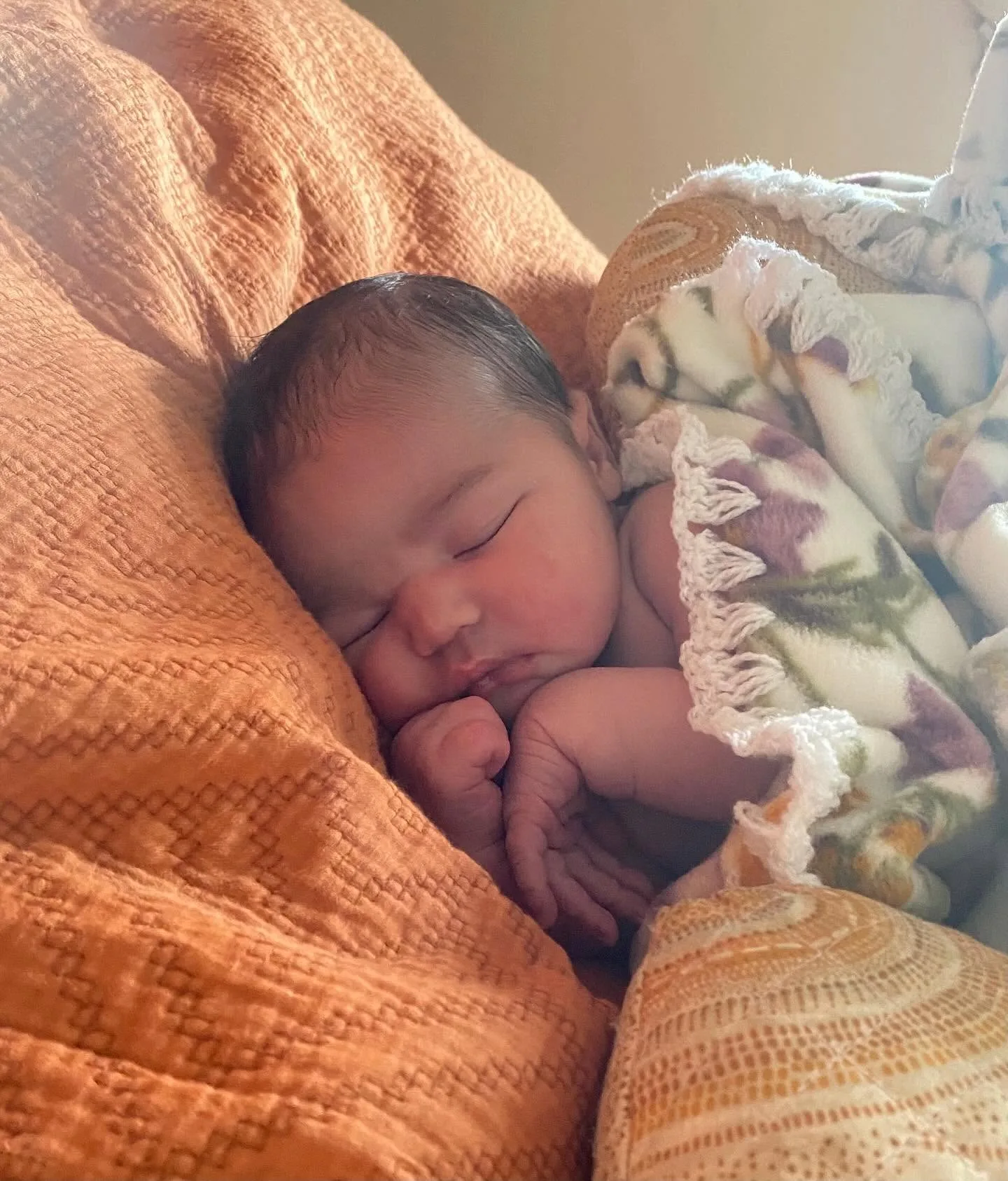 A sleeping newborn — representing the clinic's paediatric and pregnancy care